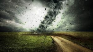 image shows a tornado tearing down a road